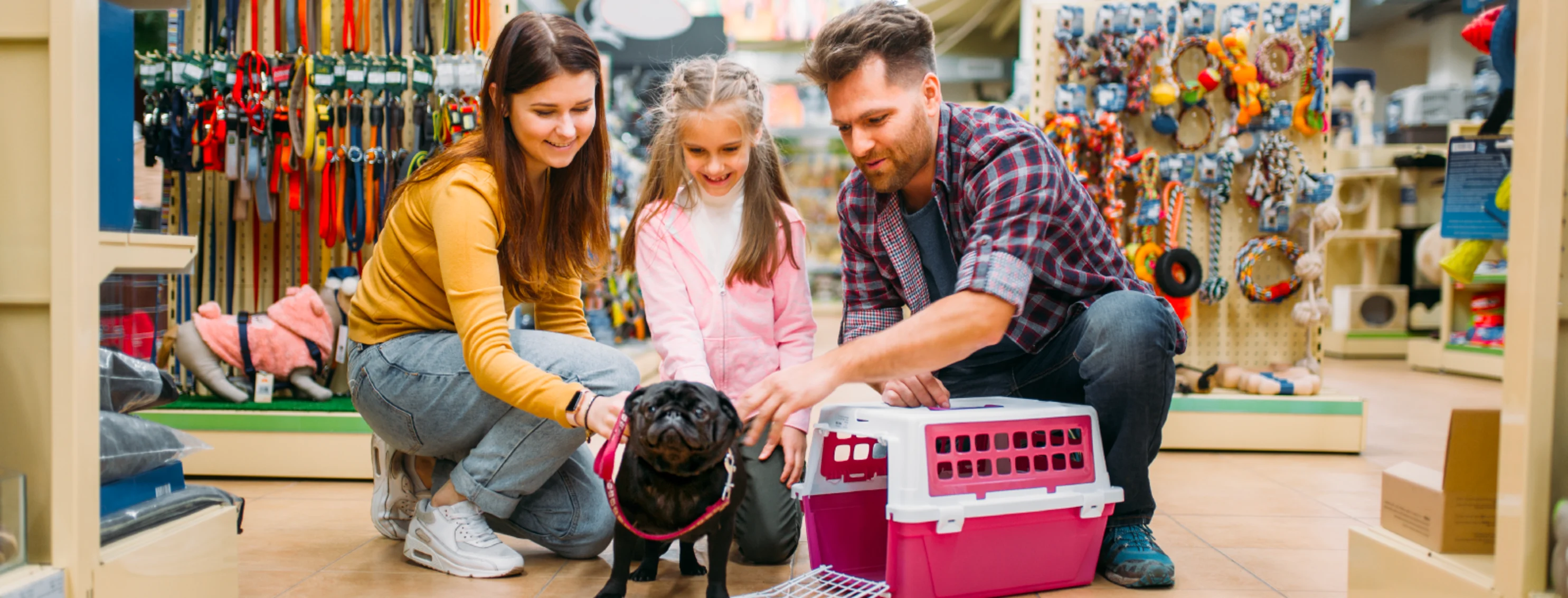 Family and dog smiling in the store